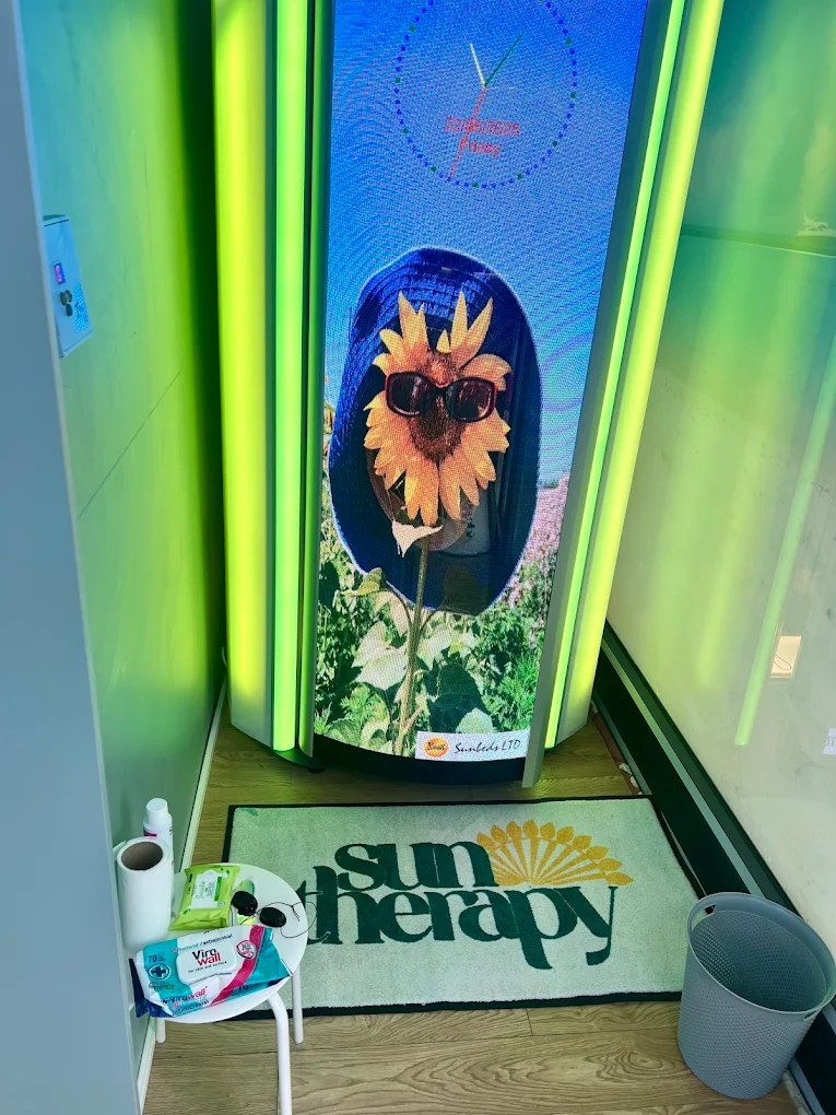Opal Fitness stand-up sunbed with its video screen door